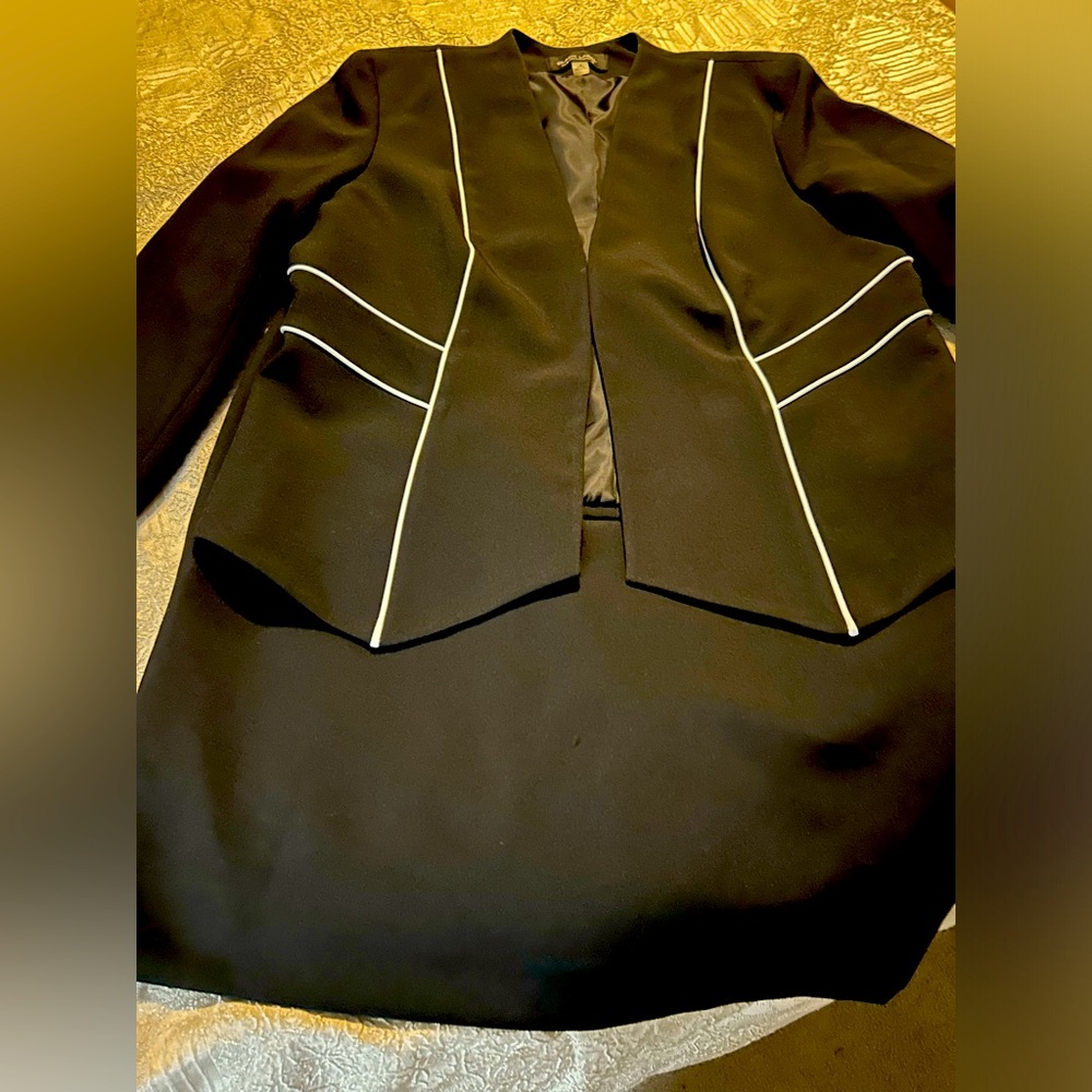 Women’s black Evan Picone suit with white accent lines on front of jacket